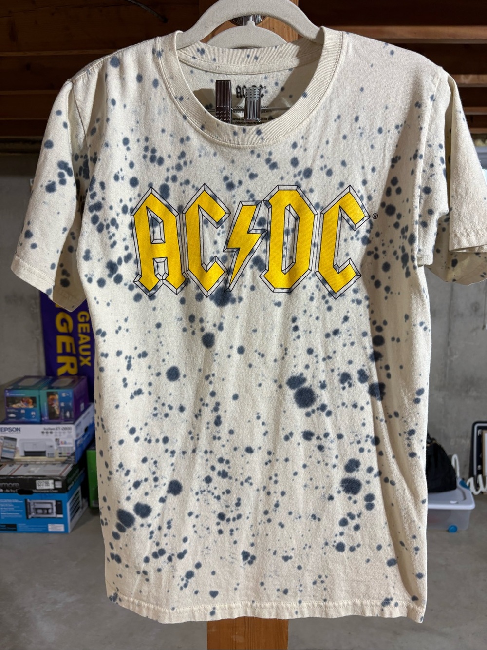 AC/DC Cream Tee with Black Charcoal Spot Pattern and Yellow Logo Accent